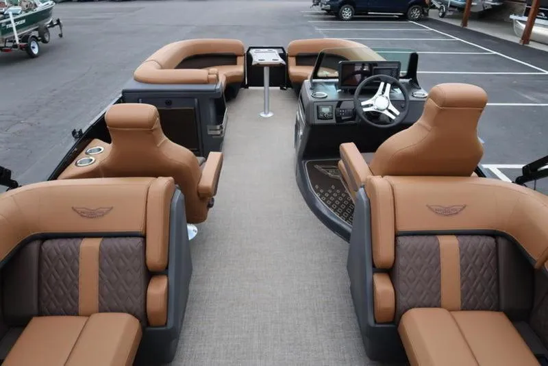 Slide: The Image of Luxurious interior of 2025 Bennington M Quad Bench 24 MFB pontoon boat with tan seating. - 4