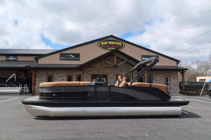 Slide: The Image of 2025 Bennington M Quad Bench 24 MFB pontoon boat outside dealership. - 6