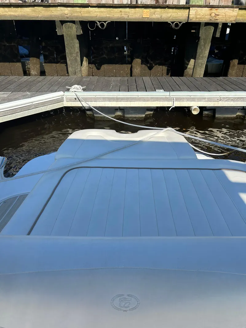 Slide: The Image of 2008 Cobalt 272 boat docked at a marina, showing rear deck and water. - 10