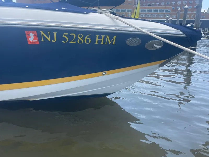 Slide: The Image of 2008 Cobalt 272 boat with NJ registration, docked in calm waters. - 12