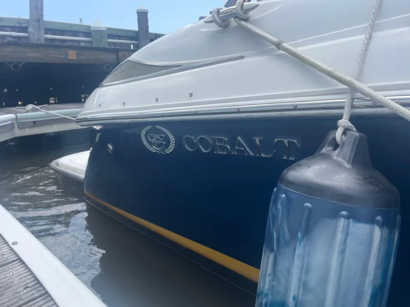 Slide: The Image of 2008 Cobalt 272 boat docked with visible logo and fender. - 13