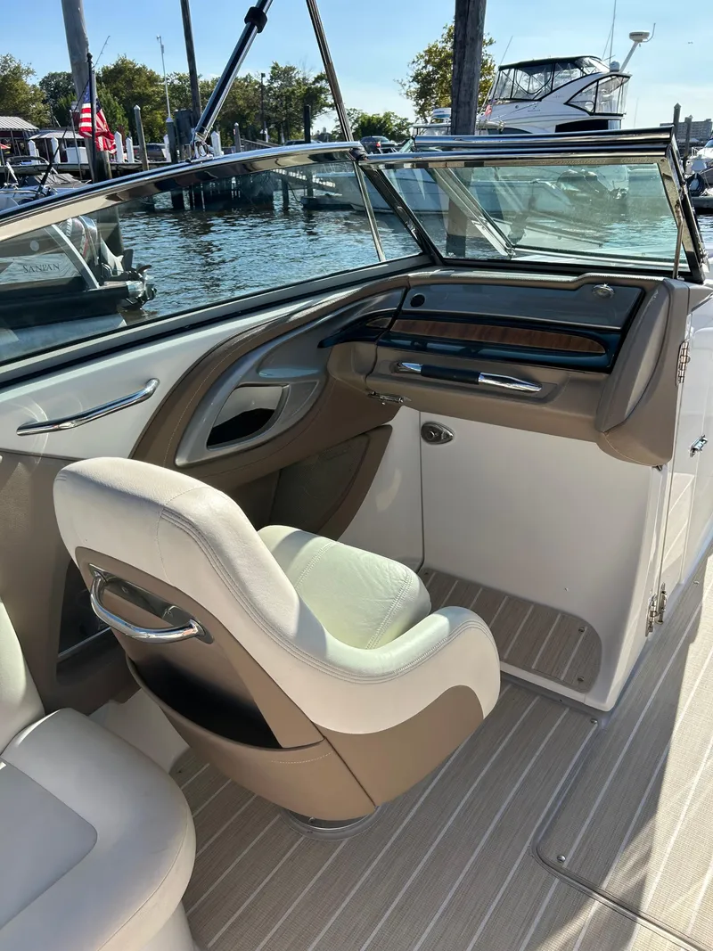 Slide: The Image of 2008 Cobalt 272 boat interior with helm seat and dashboard, docked by the water. - 7