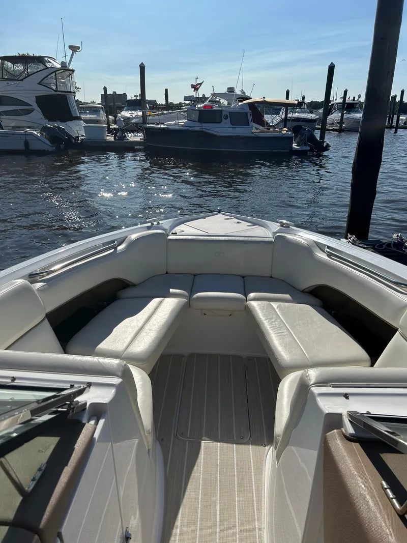 Slide: The Image of 2008 Cobalt 272 boat interior with white seating, docked at a marina. - 8