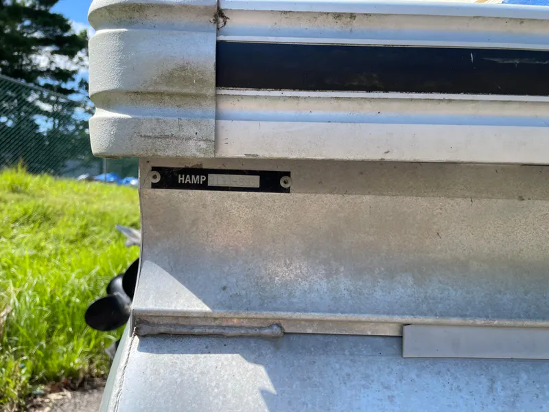 Slide: The Image of Close-up of a 1999 Harris Sunliner 240 boat's metal exterior with a nameplate. - 11