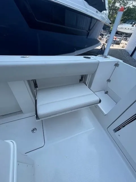 Slide: The Image of 2023 Sailfish 272 CC boat interior with foldable seat and sleek design. - 16