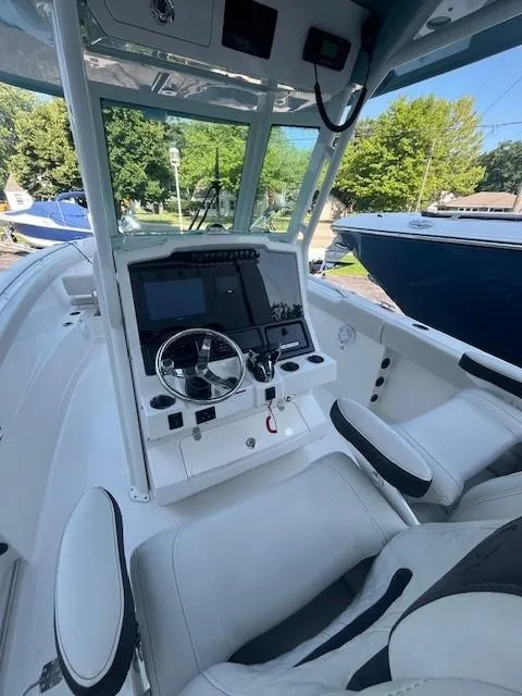 Slide: The Image of 2023 Sailfish 272 CC boat interior with modern dashboard and seating. - 6