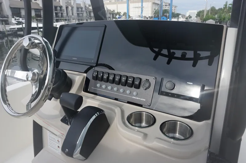 Slide: The Image of 2026 Boston Whaler 250 Dauntless helm with modern controls and steering wheel. - 13