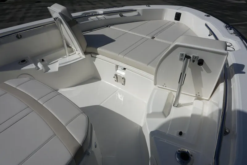 Slide: The Image of 2026 Boston Whaler 250 Dauntless boat interior with cushioned seating and storage compartments. - 16