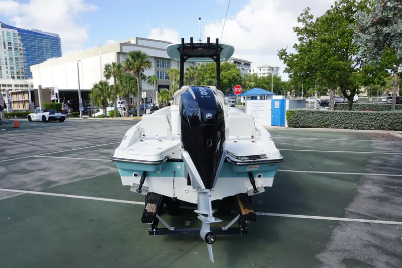 Slide: The Image of 2026 Boston Whaler 250 Dauntless boat on trailer in urban setting. - 2