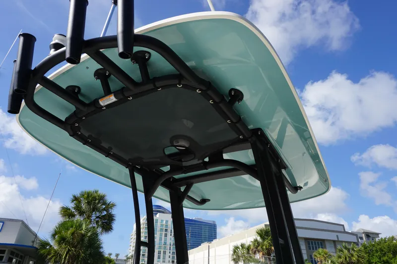 Slide: The Image of 2026 Boston Whaler 250 Dauntless T-top against blue sky and palm trees. - 23