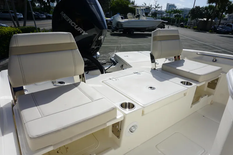 Slide: The Image of 2026 Boston Whaler 250 Dauntless boat interior with seating and Mercury engine. - 5