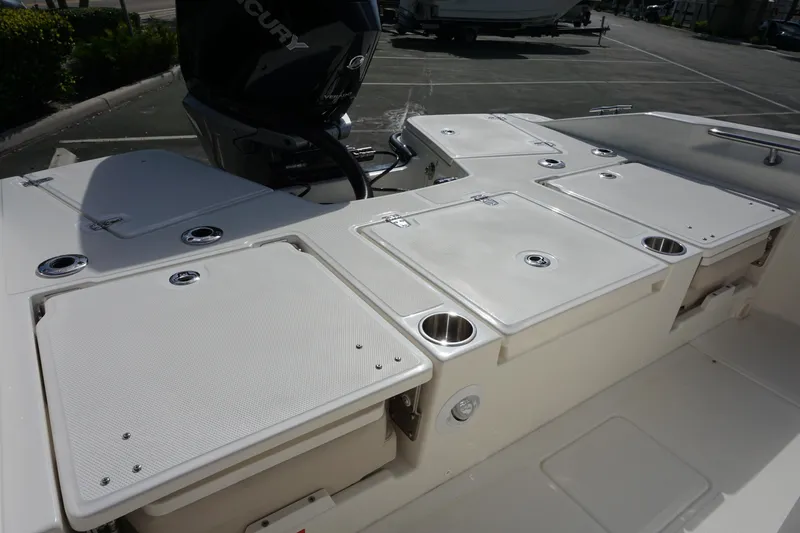 Slide: The Image of 2026 Boston Whaler 250 Dauntless boat deck with storage compartments and Mercury engine. - 6