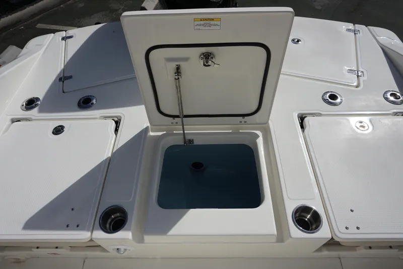Slide: The Image of 2026 Boston Whaler 250 Dauntless boat deck with open storage compartments and cup holders. - 7