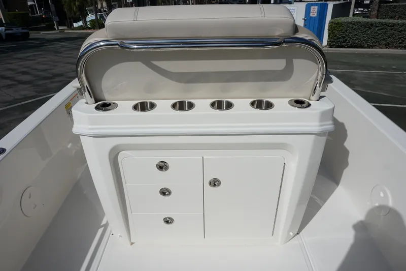 Slide: The Image of 2026 Boston Whaler 250 Dauntless boat console with cup holders and storage compartments. - 8