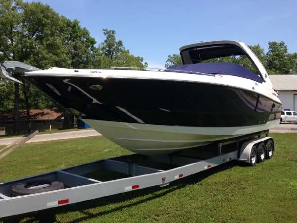 Slide: The Image of 2012 Monterey 328SS boat on trailer, parked on grass under clear sky. - 1