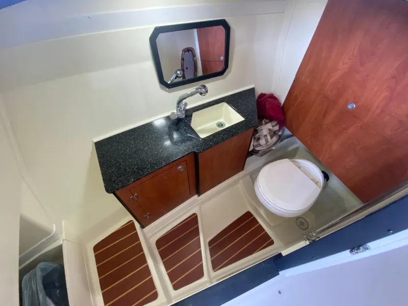 Slide: The Image of 2012 Monterey 328SS boat bathroom with sink, mirror, and toilet. - 10