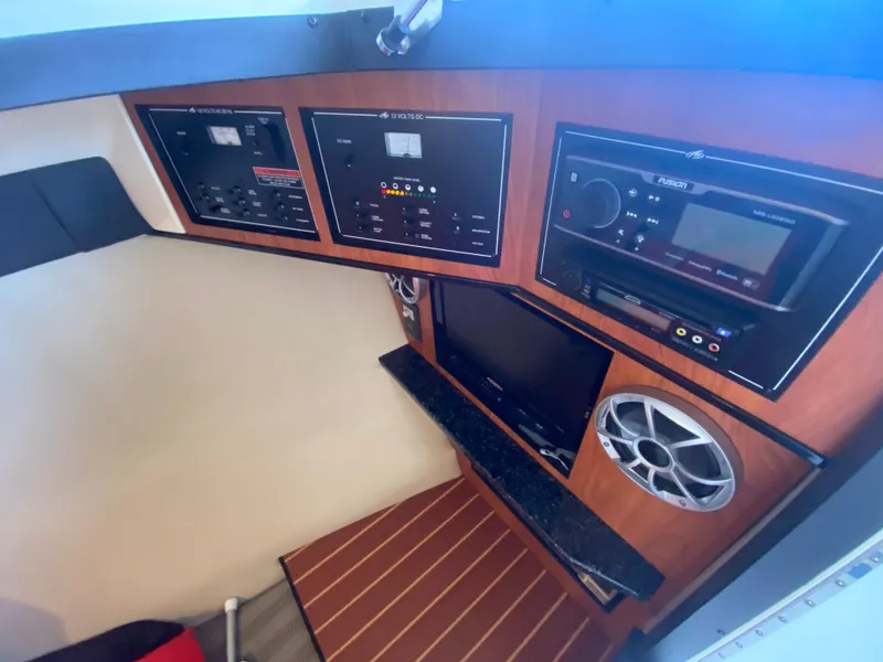 Slide: The Image of Control panel and audio system inside a 2012 Monterey 328SS boat cabin. - 11