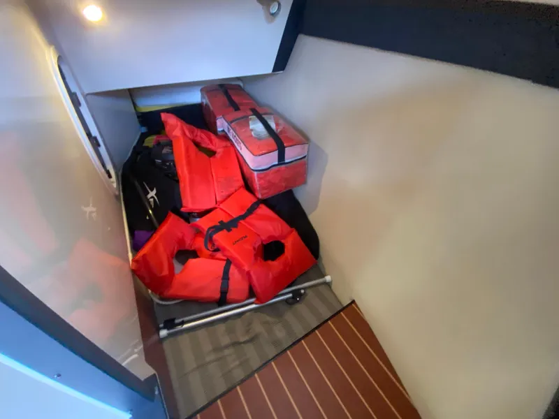 Slide: The Image of Storage area in a 2012 Monterey 328SS boat with life jackets and equipment. - 12