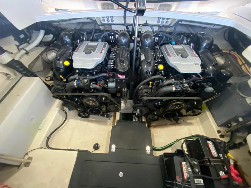 Slide: The Image of Engine compartment of a 2012 Monterey 328SS boat, featuring dual inboard motors. - 14