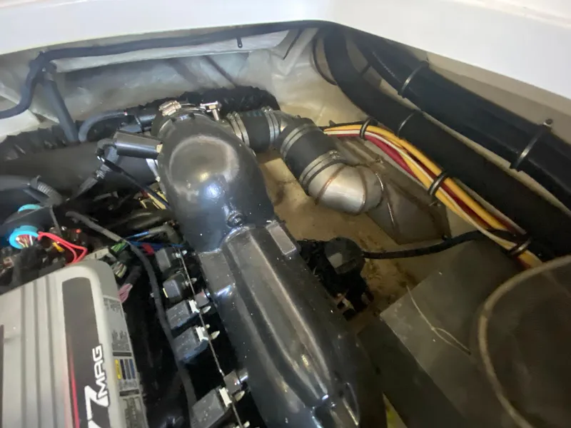 Slide: The Image of Engine compartment of a 2012 Monterey 328SS boat, showcasing mechanical components and wiring. - 16