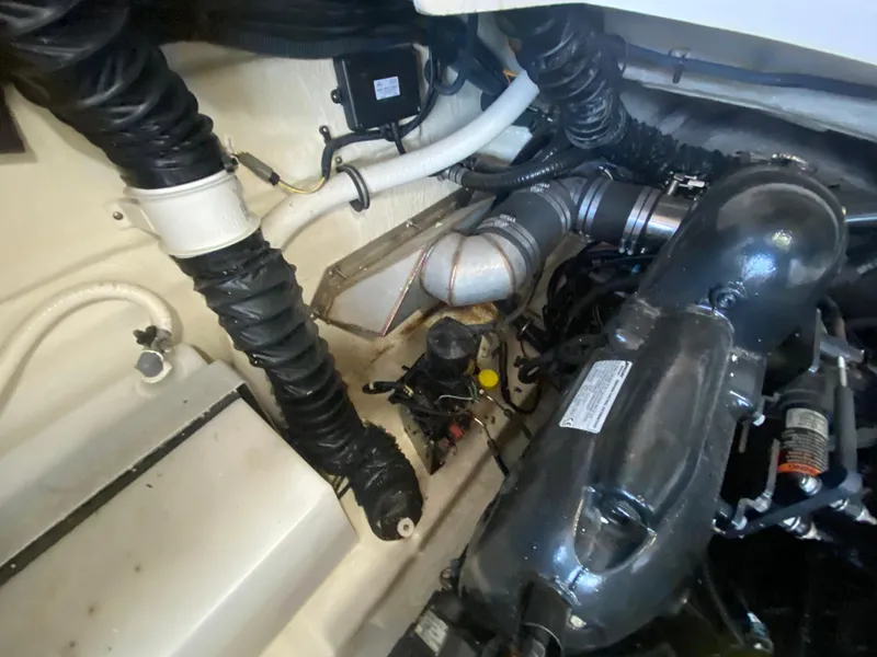 Slide: The Image of Engine compartment of a 2012 Monterey 328SS boat, showing hoses and components. - 17