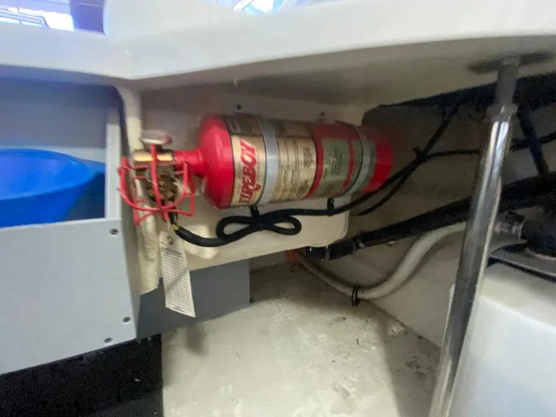 Slide: The Image of Fire extinguisher installed in a 2012 Monterey 328SS boat compartment. - 18