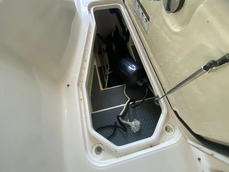 Slide: The Image of Open storage compartment in 2012 Monterey 328SS boat with ropes and equipment. - 23