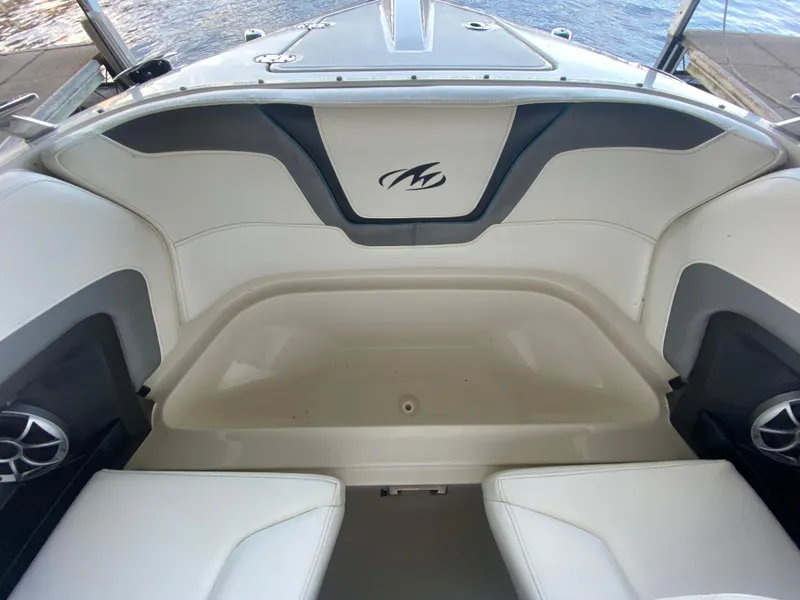 Slide: The Image of Interior of a 2012 Monterey 328SS boat with white seating and logo. - 24
