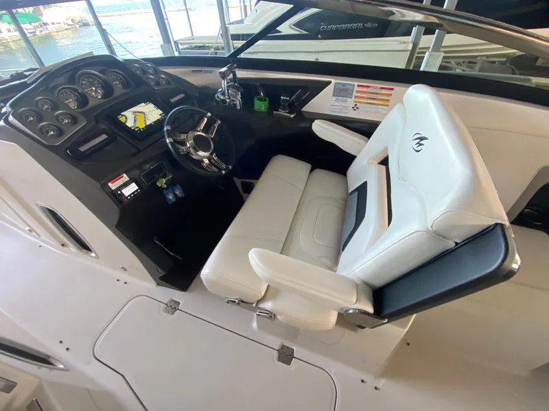 Slide: The Image of Interior of a 2012 Monterey 328SS boat with steering wheel and control panel. - 27