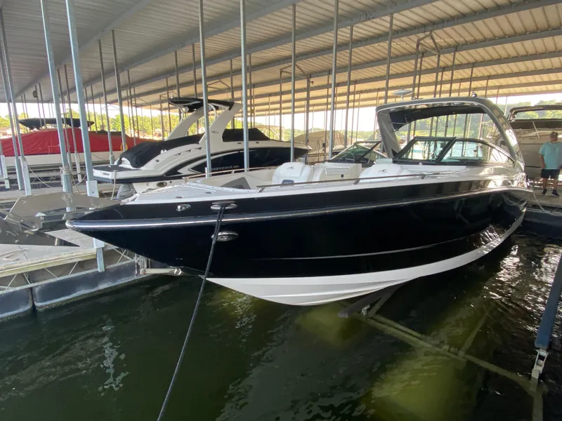 Slide: The Image of 2012 Monterey 328SS boat docked in a covered marina. - 3