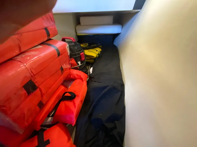 Slide: The Image of Storage area in a 2012 Monterey 328SS boat with life jackets and equipment. - 35