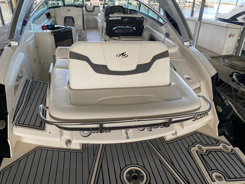 Slide: The Image of 2012 Monterey 328SS boat interior with seating and dashboard, docked at marina. - 36
