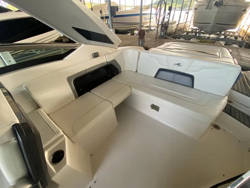 Slide: The Image of 2012 Monterey 328SS boat interior with white seating and cup holder. - 39