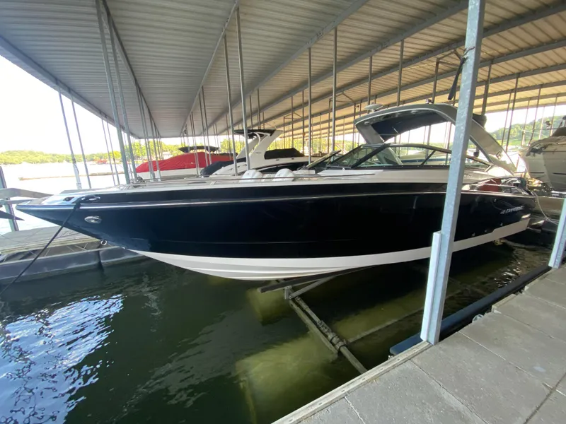 Slide: The Image of 2012 Monterey 328SS boat docked under a covered marina. - 4