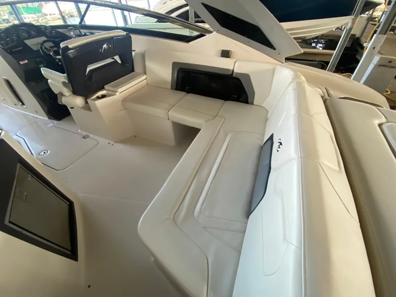 Slide: The Image of Interior of a 2012 Monterey 328SS boat with white seating and helm. - 40