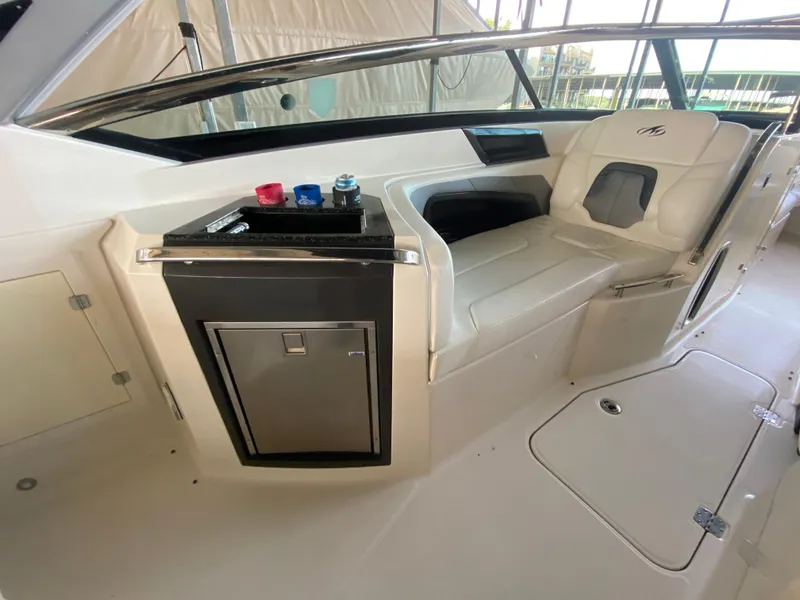 Slide: The Image of Interior of a 2012 Monterey 328SS boat with seating and mini fridge. - 41