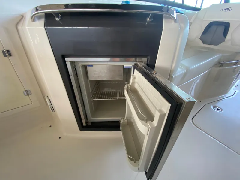 Slide: The Image of Open refrigerator on 2012 Monterey 328SS boat, showcasing interior storage space. - 42