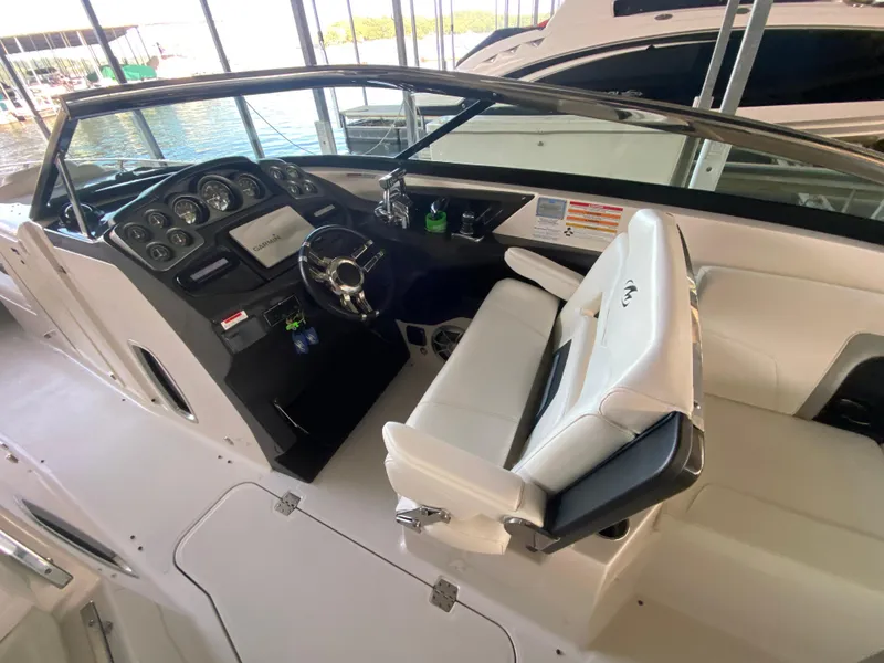 Slide: The Image of 2012 Monterey 328SS boat interior with steering wheel and dashboard controls. - 43
