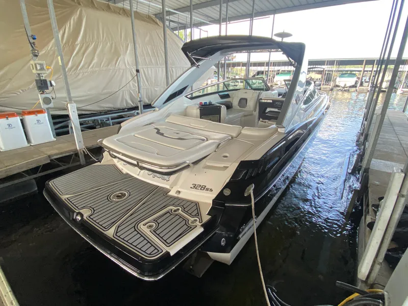 Slide: The Image of 2012 Monterey 328SS boat docked in a marina, rear view. - 46