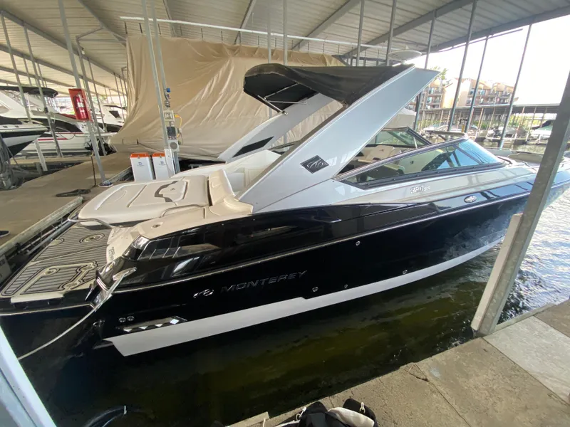 Slide: The Image of 2012 Monterey 328SS boat docked in a covered marina. - 47