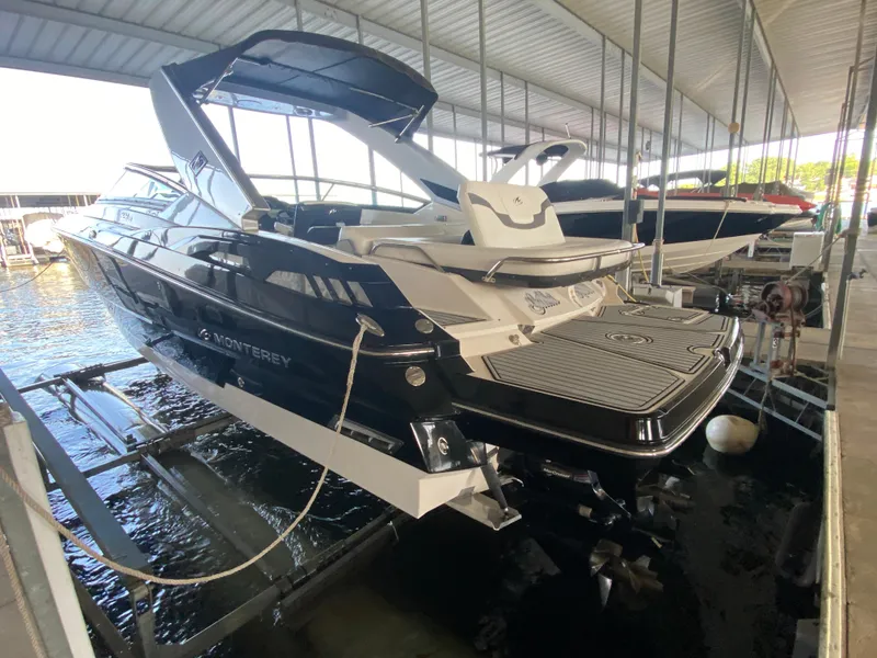 Slide: The Image of 2012 Monterey 328SS boat docked in a covered marina. - 5
