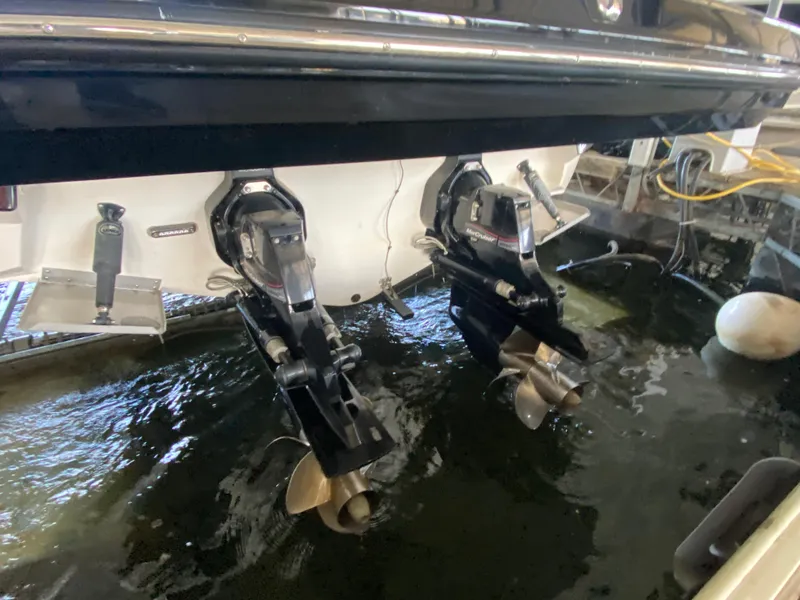 Slide: The Image of 2012 Monterey 328SS boat stern with dual outboard motors in water. - 6