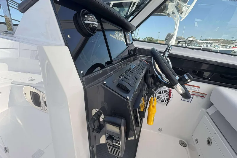 Slide: The Image of 2026 Blackfin 272 DC boat cockpit with steering wheel and control panel. - 10