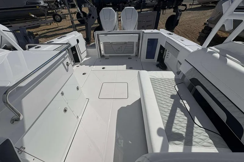 Slide: The Image of 2026 Blackfin 272 DC boat interior with white seating and storage compartments. - 14