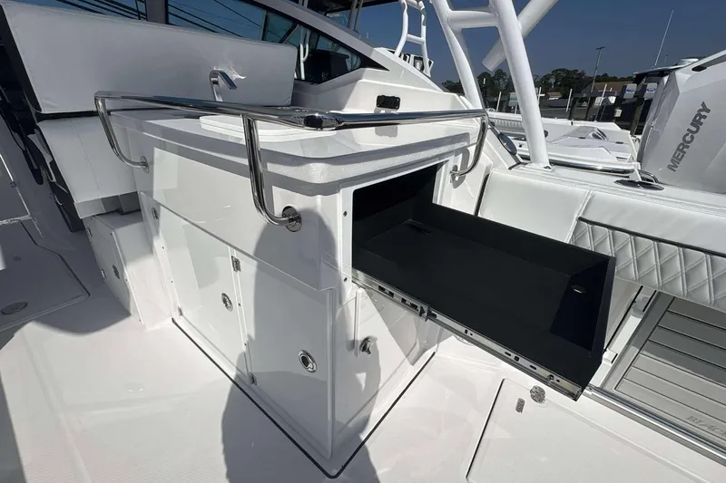 Slide: The Image of 2026 Blackfin 272 DC boat interior with storage compartment and sleek design. - 16