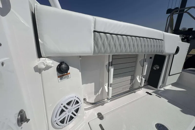 Slide: The Image of 2026 Blackfin 272 DC boat interior with cushioned seating and speaker detail. - 18