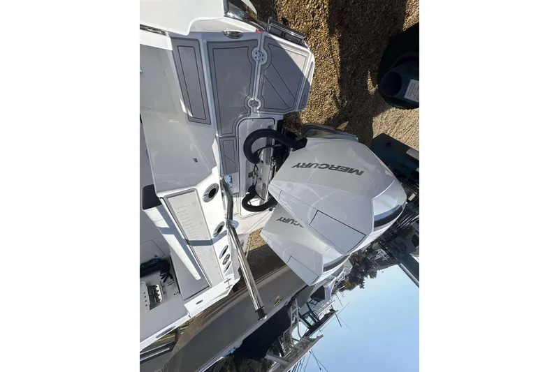 Slide: The Image of 2026 Blackfin 272 DC boat with Mercury engine, docked and ready for adventure. - 19