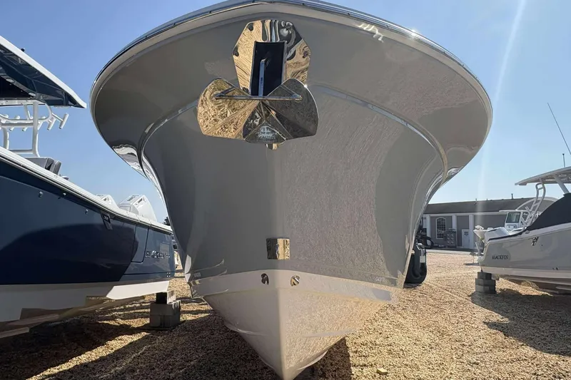 Slide: The Image of 2026 Blackfin 272 DC boat, front view, displayed outdoors under clear sky. - 2