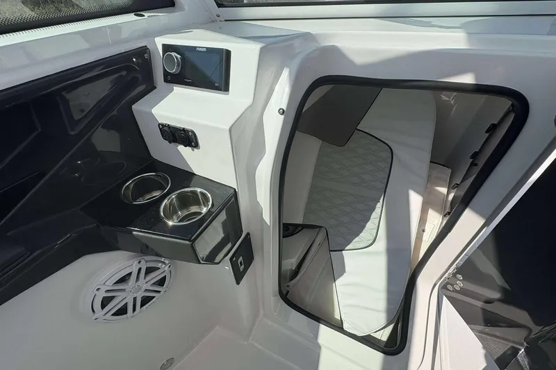 Slide: The Image of 2026 Blackfin 272 DC boat interior with cup holders and cabin entry. - 22