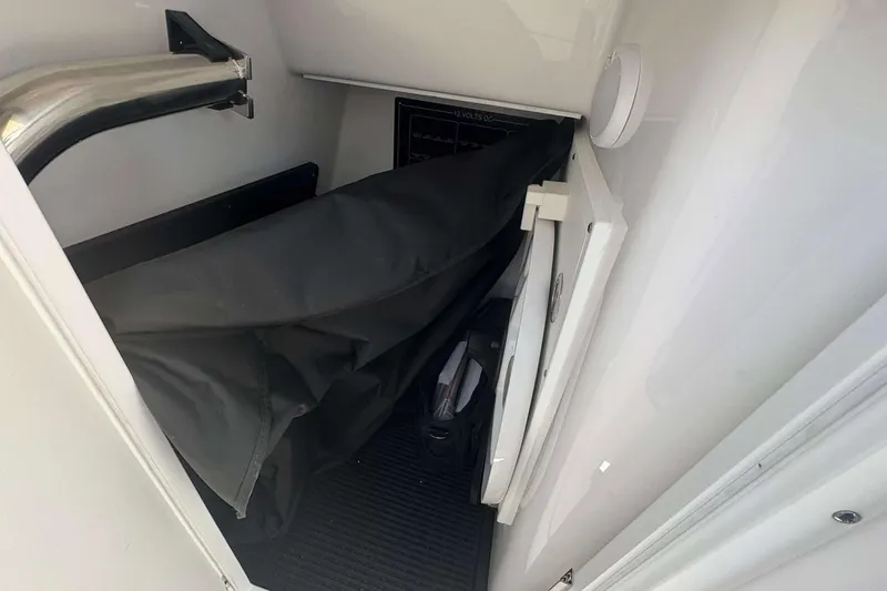 Slide: The Image of Interior storage compartment of 2026 Blackfin 272 DC boat, featuring a folded cover. - 24